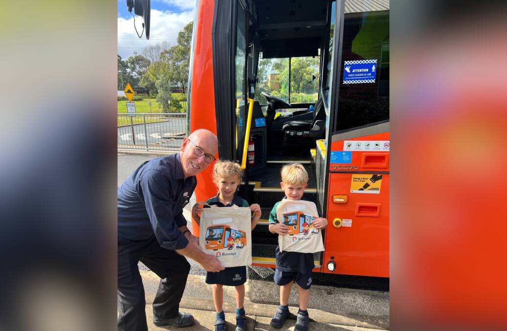Jemima and Vinnie receive their gift bags and bus safety hero certificate from veteran bus driver and Busways educator Murray White. Picture supplied by Busways