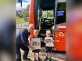 Jemima and Vinnie receive their gift bags and bus safety hero certificate from veteran bus driver and Busways educator Murray White. Picture supplied by Busways