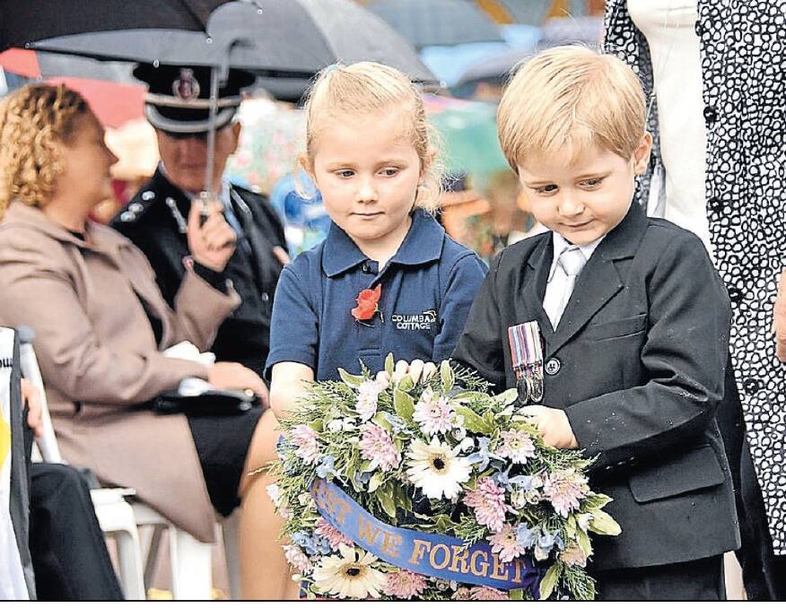 Marchers of the future: Rhianna Butler and Liam Higgins lay a wreath at the Port Macquarie Cenotaph at last year's service.