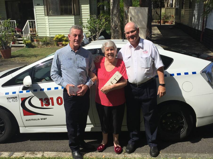 Million milestone: Port Macquarie Taxis general manager Steve Read and taxi driver David Thornton congratulating Maureen Howie on being the one millionth journey.