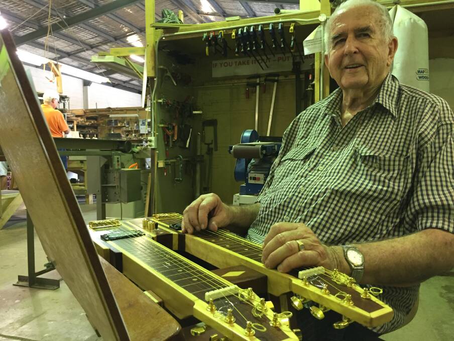 Ready to play: Brian Calbert enjoying playing his hand-made twin-neck guitar at the Hastings Men's Shed. Photo: Peter Daniels