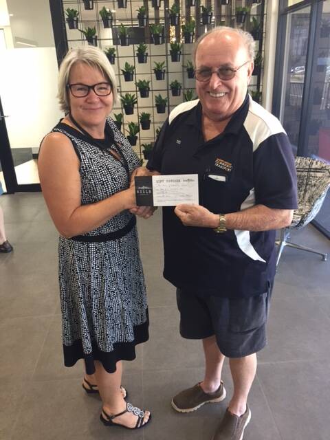 Ted's a winner: Port Macquarie's Ted Laing picking up his $50 voucher for Bills Fishhouse + Bar from Port Macquarie News' Debbie Barnard.