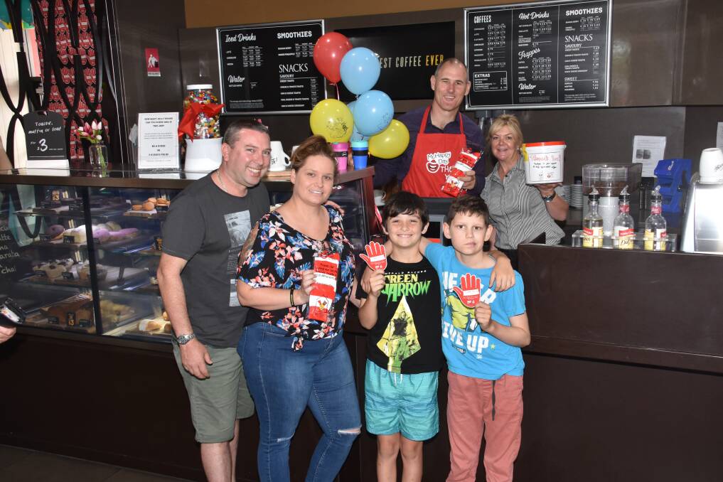 Let's get happy: Rob and Suzanne Turpie with Domonic McArdle and Caleb Scott celebrating McHappy Day with mayor Peter Besseling and McDonalds franchise owner Jacqui Jones.