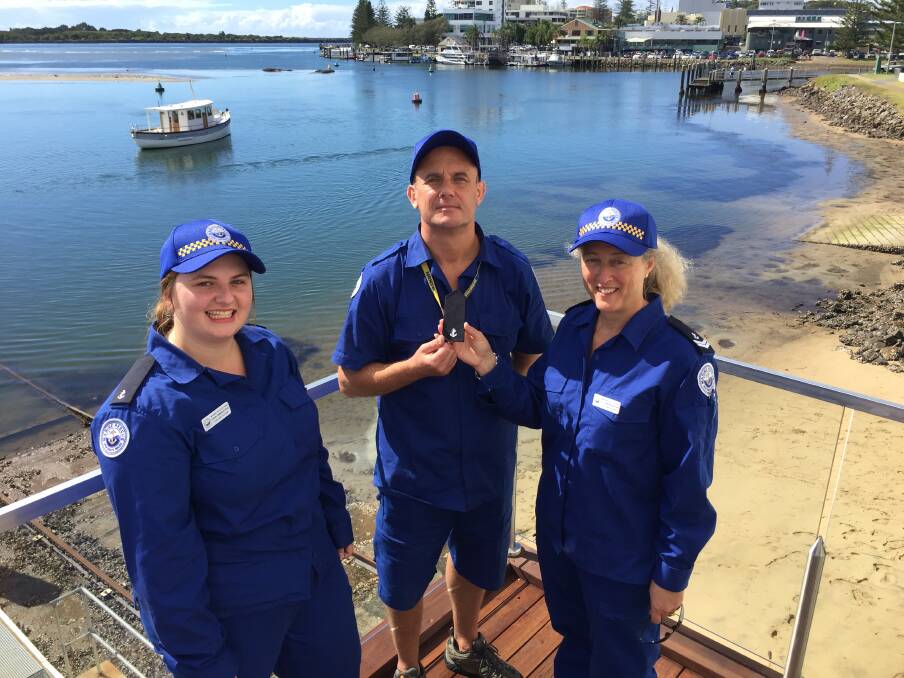The recruits: Marine Rescue Port Macquarie training officer Ali Cameron-Brown congratulating Darran Saunders on successfully completing his crew assessment as fellow recruit Erin Emmerton looks on.