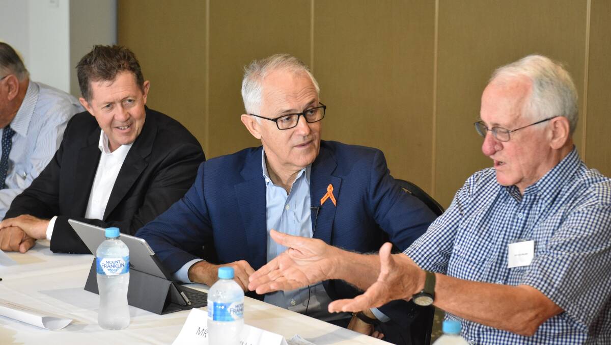 Travel plans: Federal MP Luke Hartsuyker, Prime Minister Malcolm Turnbull and Willie Millard at Wednesday's roundtable in Port Macquarie. Photo: Ben Burley