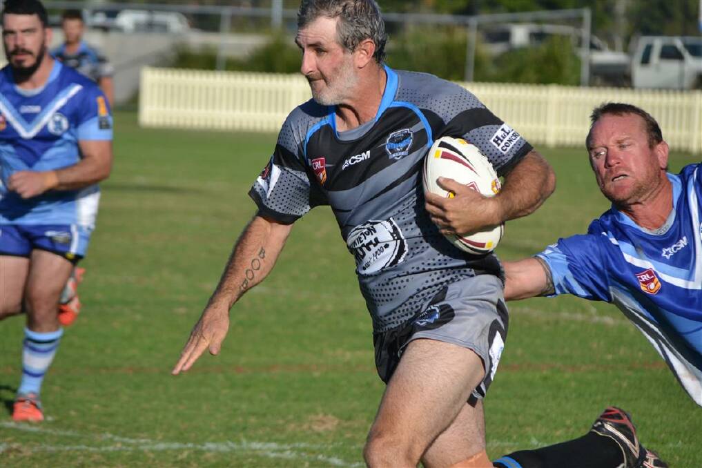 On the run: Damon Booby escaping the clutches of Chris Hanlon in the Stingrays clash with Kendall. The two clubs will host a double-header at Laurieton Oval this Saturday.
