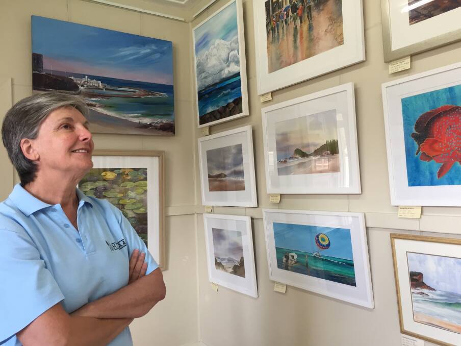 New exhibition: Hastings Valley Fine Art Association president Bernice Daher, inspecting the new selection of locally produced art now on display at their rooms at the eastern end of William Street overlooking Oxley Beach. 