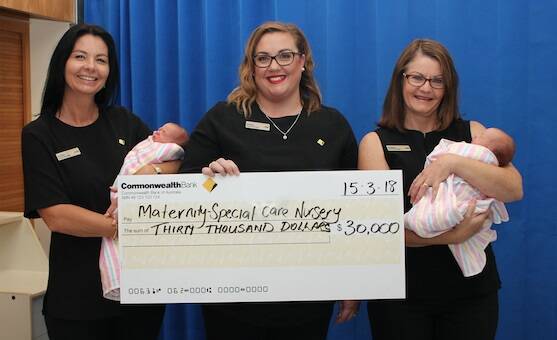 Port Macquarie Branch Manager Corrine Wickham, Wauchope Branch Manager Lauren Pye and Laurieton Branch Manager Pauline Hoad present $30,000 for specialised patient equipment to Port Macquarie Base Hospital. Among the special guests at the presentation were new-born twins Thea and Sage Wheeler.