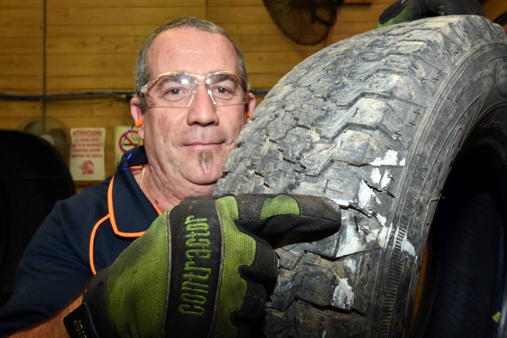 Breakdown capital: Beaurepaires store manager Adam McCrystal with a ruptured tyre. Pic: Ivan Sajko