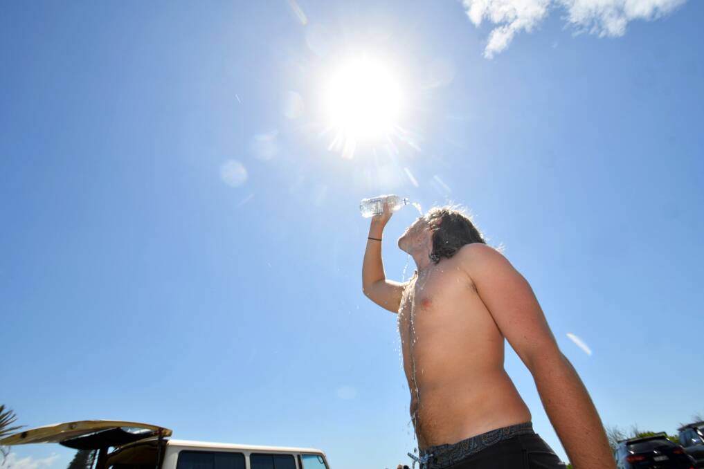 Hot and humid: Melbourne visitor Caleb Watkins cooling off. Hot and humid weather conditions are likely to continue through to Sunday. Photo: Ivan Sajko