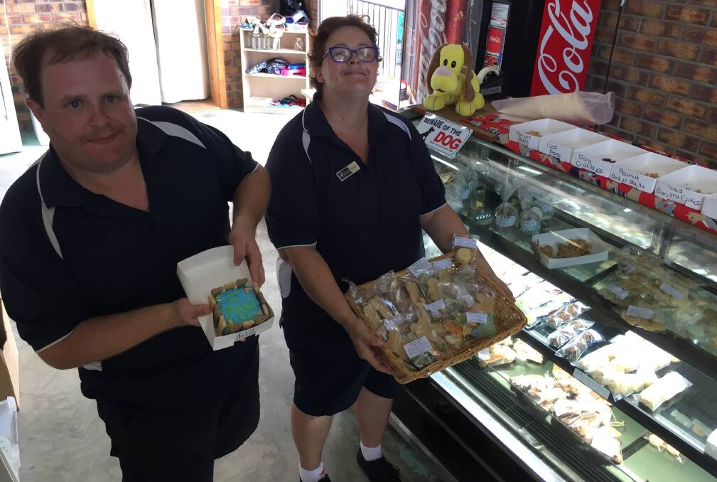 New enterprise: Willing & Able op shop workers Adam and Debbie with some of their latest selection of dog treats.