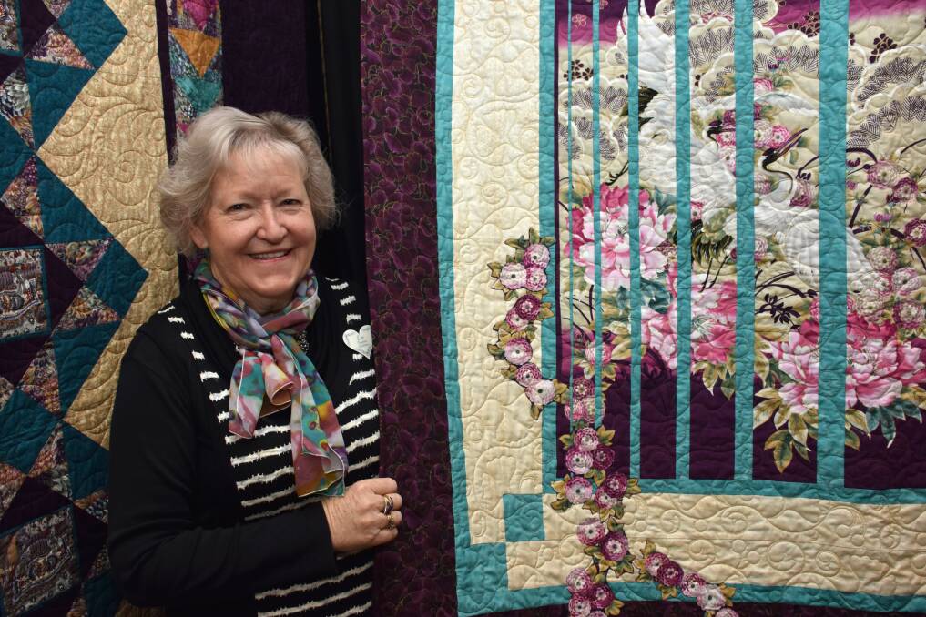 Quilt success: Lee McGlashan displaying one of her quilts at the Timeless Quilters expo at Panthers Port Macquarie.