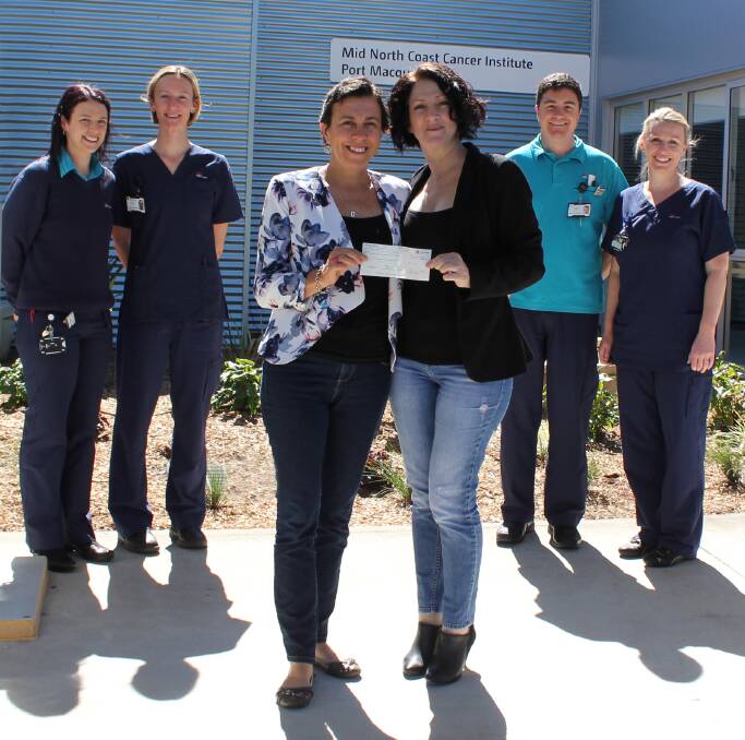 Donation: Former cancer patient Kathy Gilmour and her best friend Yasmin Williams, centre, reunite with some of the Mid North Coast Cancer Institute team, Jenna Dean, Eleanor Price, Luke Kerin and Kirsty Baxter. The pair presented the Port Macquarie campus with a $7500 donation.