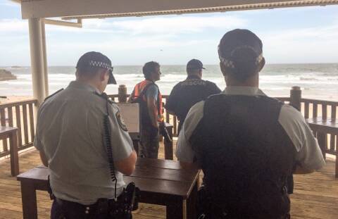 Emergency service personnel are searching for a swimmer, believed missing, off Flynns Beach.