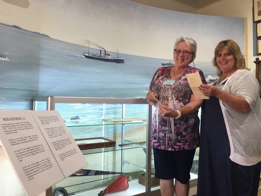 Road show: Mid North Coast Maritime Museum volunteers Ingrid Kennewell and Diane White inspecting the Wollongbar II exhibition at the Port Macquarie headquarters.
