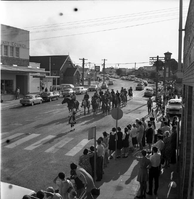Historic ride: This wonderful photographs from the Wauchope District Historical Society files shows the John Oxley sesquicentenary commemorative ride down High Street Wauchope.