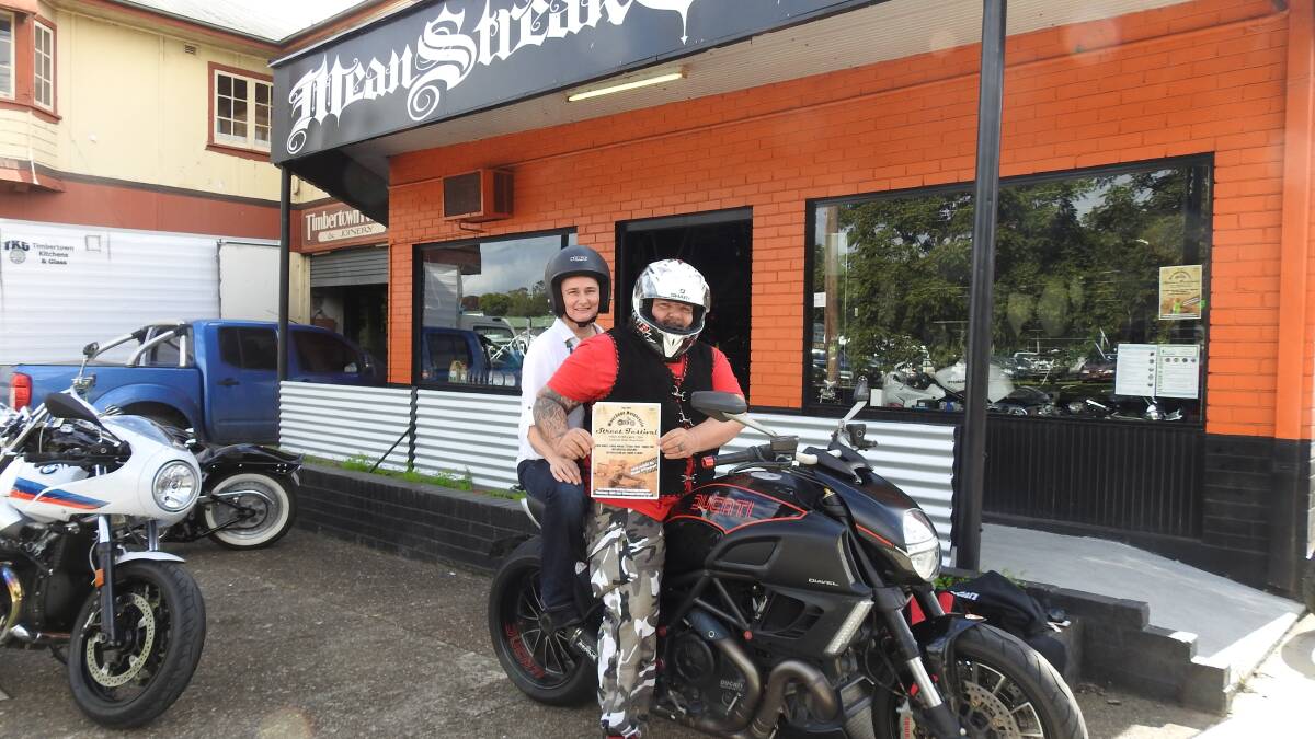 Jenny Pursehouse from Motorcycle Friendly Wauchope and bike enthusiat Todd Taylor with a poster for the Ulysses AGM street festival on Friday May 26.