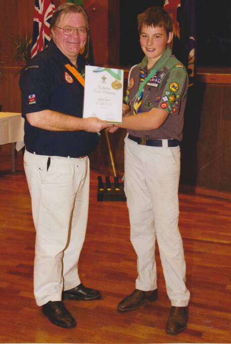 RARE ACHIEVEMENT: Chief commissioner of Scouts Australia Neville Tomkins OAM presents Lachlan Eggert with the Australian Scout Medallion.