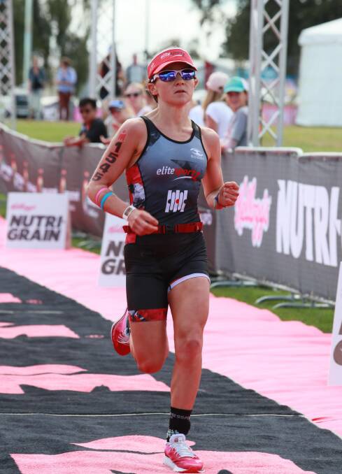 Winner: Madi Roberts in the finishing chute as she wins Ironman 70.3 New Zealand. Photo: FinisherPix