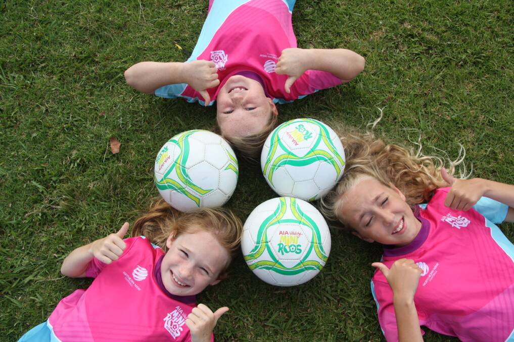 Thumbs up: Kate Ainsworth, Laura Norris and Milla Swain love their football. Photo: Supplied