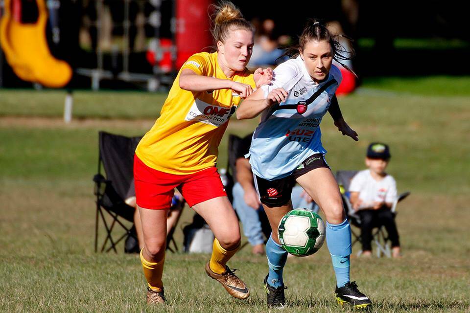 Getting physical: Shannon Day jostles for possession during Mid North Coast's 4-3 win over South Wallsend.