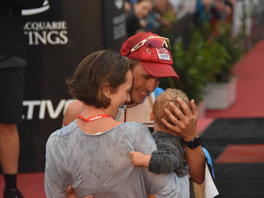 Family first: Tim Reed celebrates with wife Monica and son Oscar after winning last year's Ironman Australia Port Macquarie.