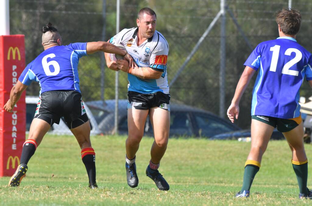 On the charge: Sharks front-rower Tom Maguire breaks through the Macquarie Scorpions defence in last month's trial. Photo: Ivan Sajko