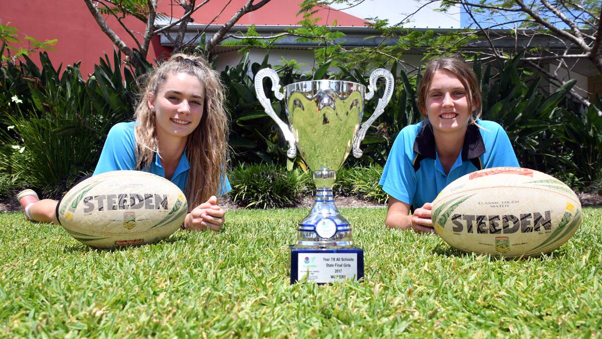 Winners: St Joseph's Regional College touch football stars Shannon Burton and Tahlia Hopkins with the NSW All-Schools touch football trophy. Photo: Ivan Sajko