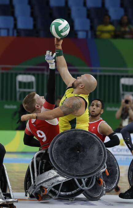 Challenging: Ryley Batt fights for the ball with Britain's Jim Roberts during a mixed wheelchair rugby group A match at the Paralympic Games in Rio. Photo: AP Photo/Leo Correa.