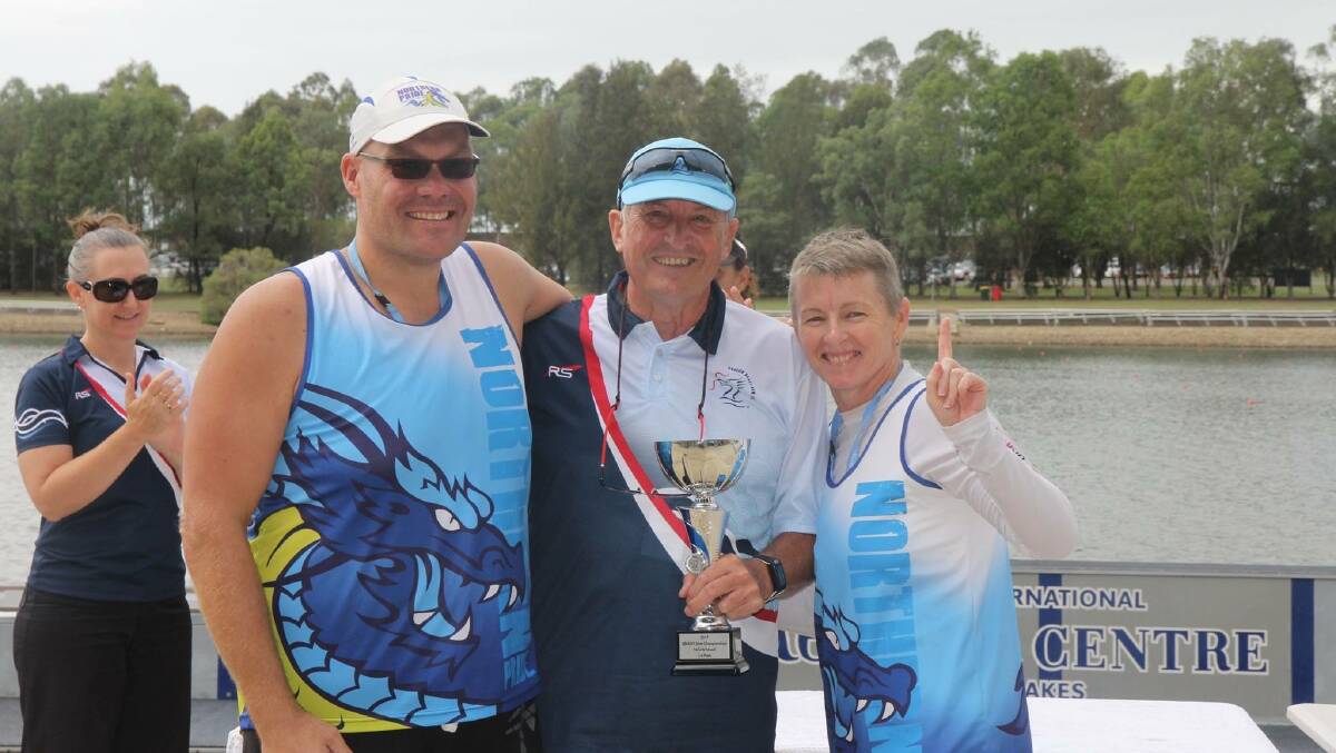 Andrew Blundell with Dragon Boat NSW president Geoff Roberts and Kim Blundell accept gold.