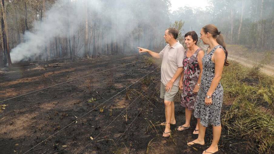 Richard and Elizabeth Bibby and their daughter Susanne Miller inspected the remains of the bush fire that came close to their property.
