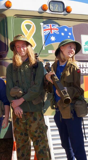 Part of history: Port Macquarie Campus students Jordan Jones and Nicole Steer got to don fatigues and handle items from the Nambus mobile museum.