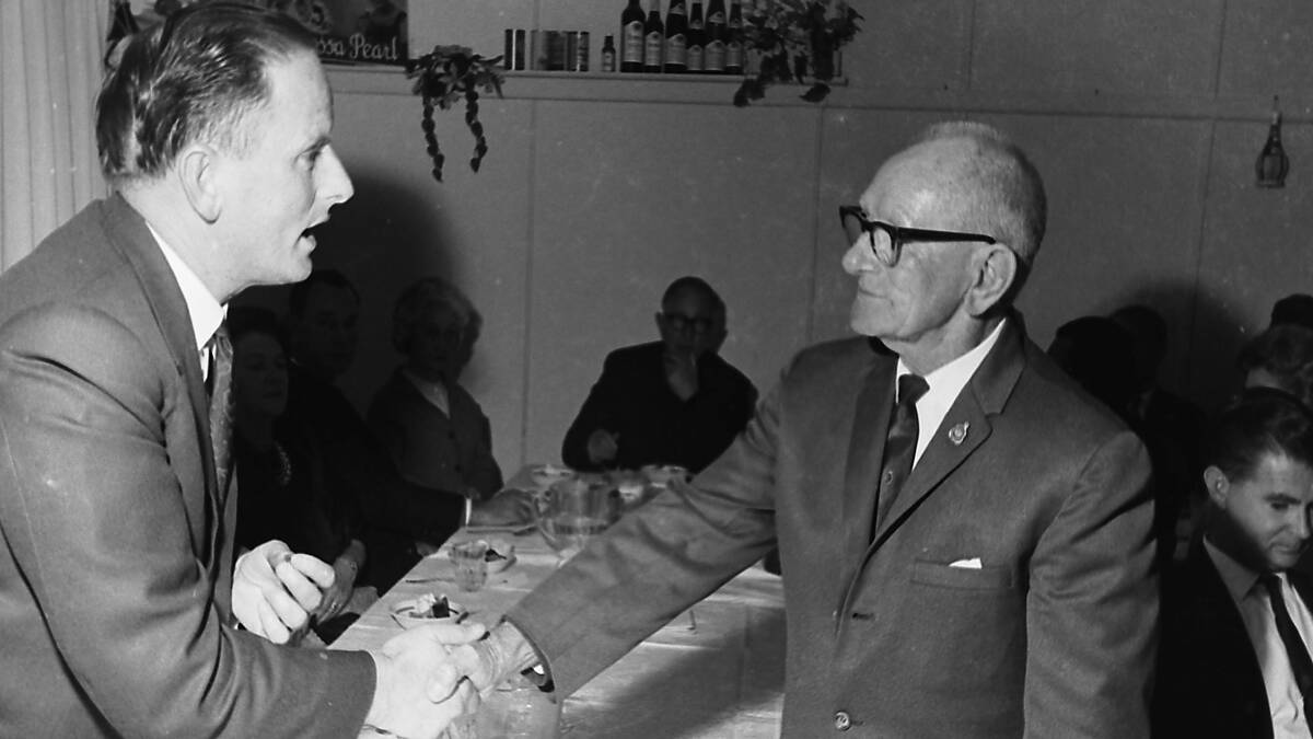  Top driver:Mr S Dickens (right) receives an award from the Minister for Road Transport, Mr. M.A. Morris, for 50 years of conviction-free driving.
