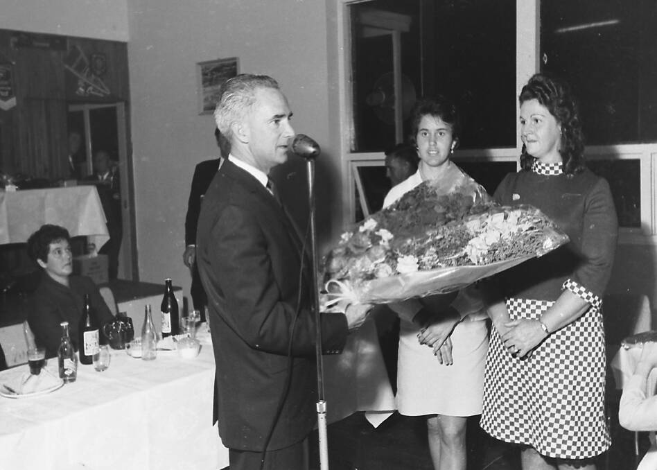 Well done: Vern Little presents Mrs Fred Denning and Mrs Denning with floral bouquets to mark their successes at the Australian Championships during the Angling Club presentation night held the week before the annual general meeting, 1967.