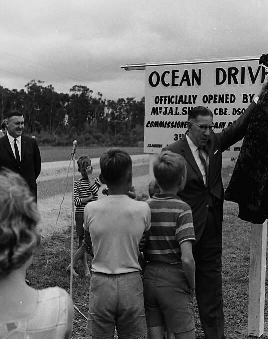 Special occasion: Commissioner for Main Roads, Mr Shaw unveils the new Ocean Drive signage on the sealed section of road from North Haven to Lake Cathie, 1966.