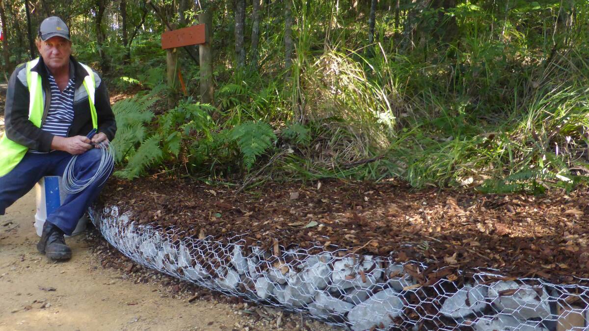 Great work: Friends of Kooloonbung thank ETC's Walker Coullhand his team for work they have done, such as this drainage mitigation site below Hollingsworth St.