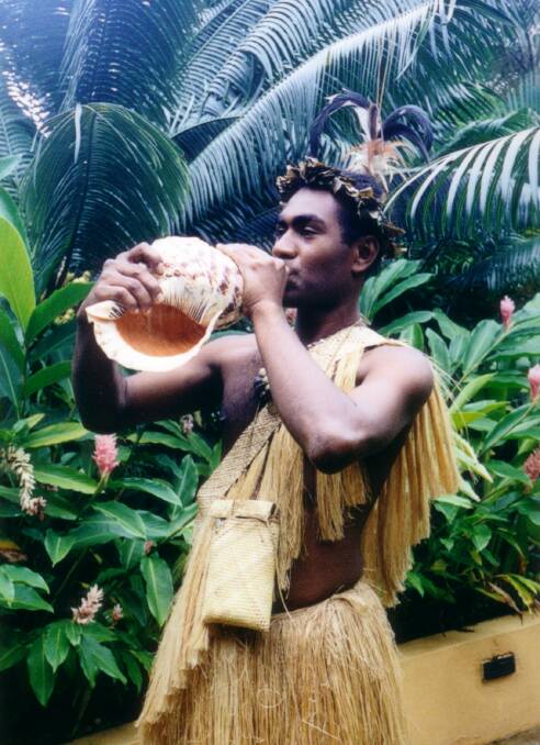 Traditional welcome: A 'warrior' from Vanuatu is ready to serenade Aussie tourists on a conch shell.