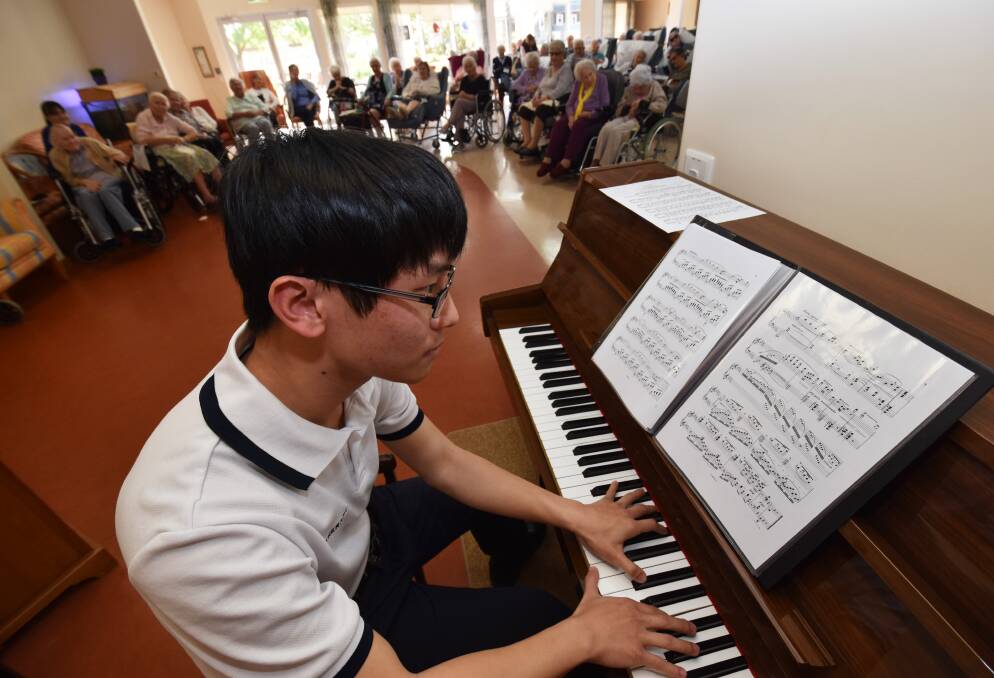 Healing hands: University of Sydney student Tin Wu gives a recital for residents at Emmaus Nursing Home, where he has had five week's practical work for his degree.