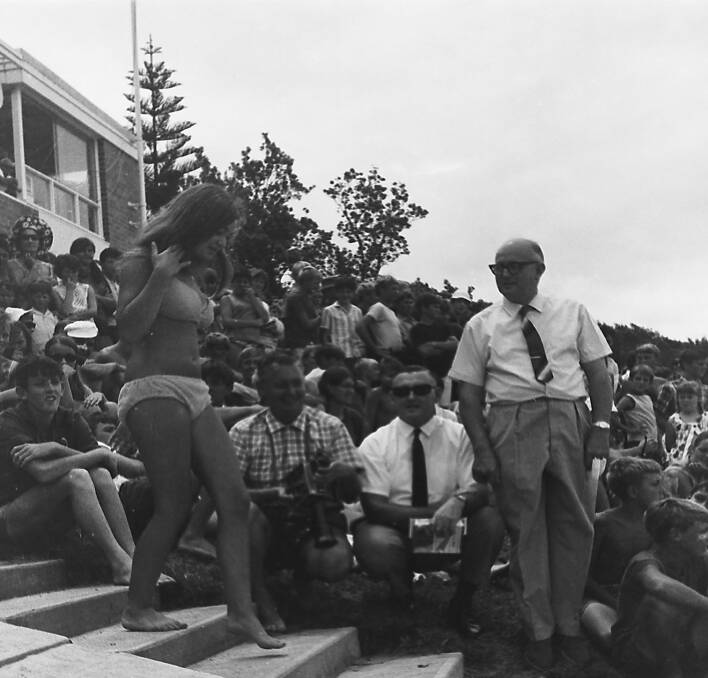 TV cameraman Ken Dick, State Member Bruce Cowan (sunglasses) and Mayor Ald. Adams (standing), during the beach girl competition at the Sesqui-centenary Surf Carnival, 1968.