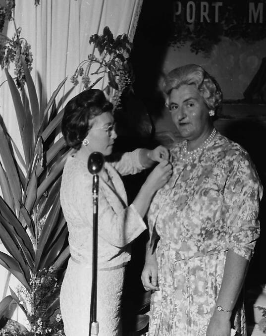 Top score: Enid Hudson receives her Port Macquarie Golf Club Associates Life Membership badge from associates president Betty Hicks, 1964.