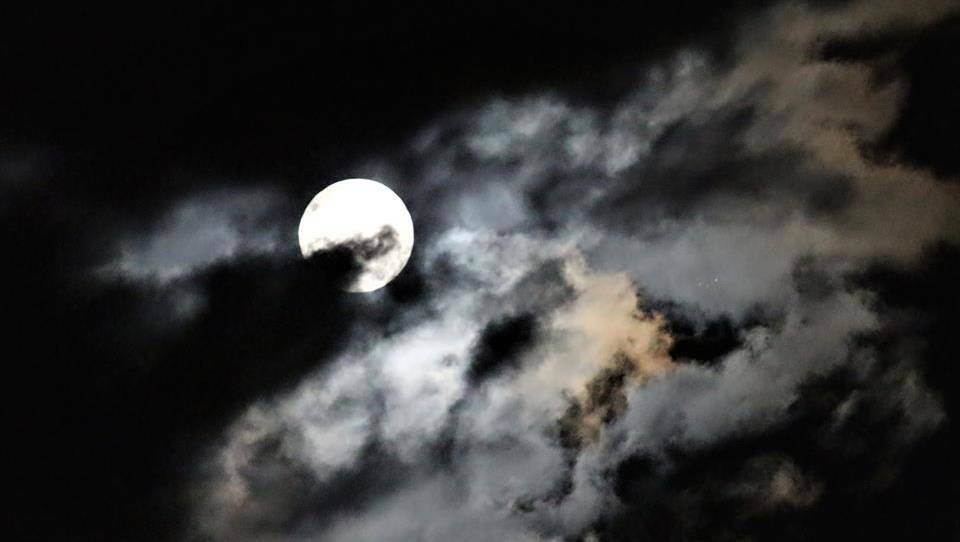 Clouds provide stunning contrast for photographers during the December supermoon. CLICK THE PHOTO TO SEE MORE