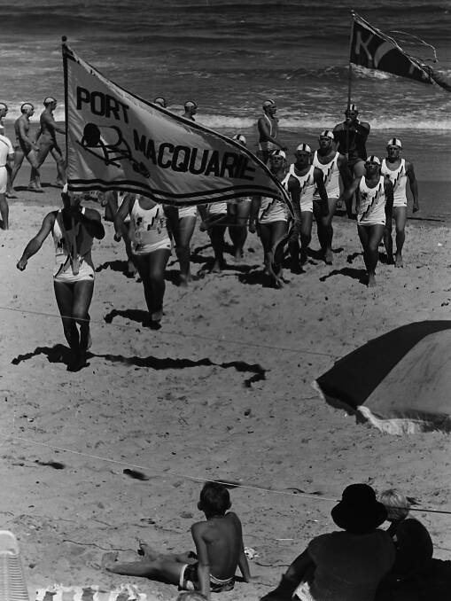 FLASHBACK: Members of the Port Macquarie Surf Club march past team put on a display for local beachgoers at Lighthouse Beach in 1967. 