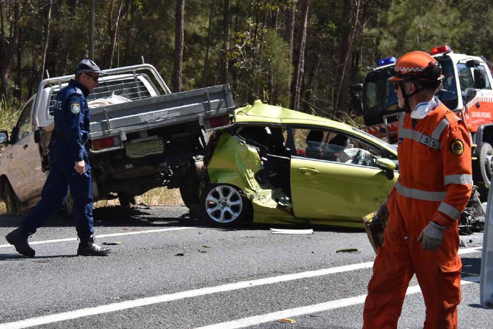 Horror stretch: Emergency services crews on-site at a highway crash where a woman has lost her life. Photo: Ivan Sajko.