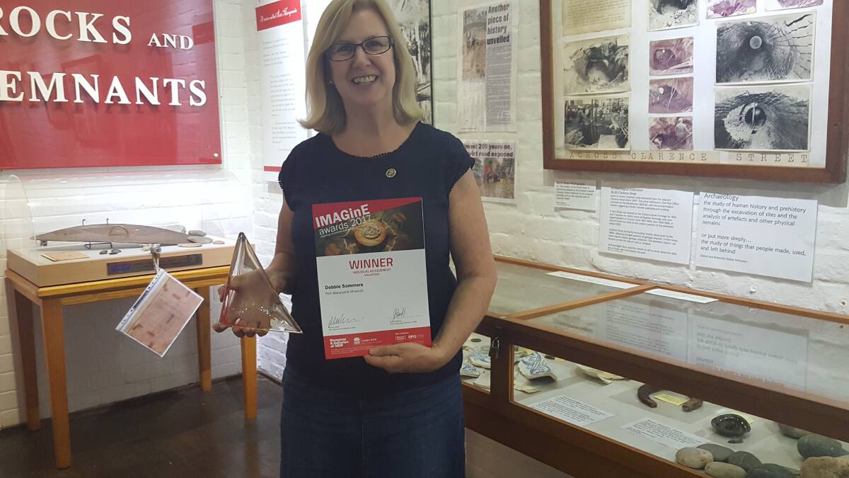GREAT JOB: Debbie with her award at the Port Macquarie museum. Photo: Laura Telford.