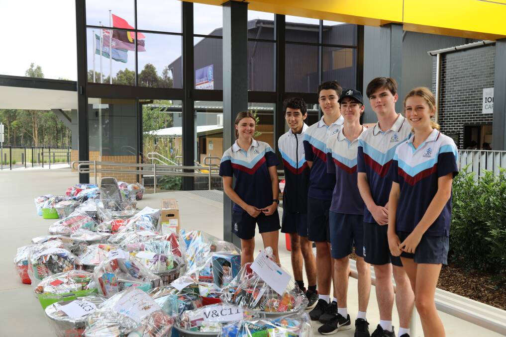 GIVING BACK: St Columba Students Olivia Stanley, Christopher Coorey, Lucas Grigg, Thomas Adnum Joshua Blue and Molly Moore with just some of the hampers donated. PHOTO: SCAS.