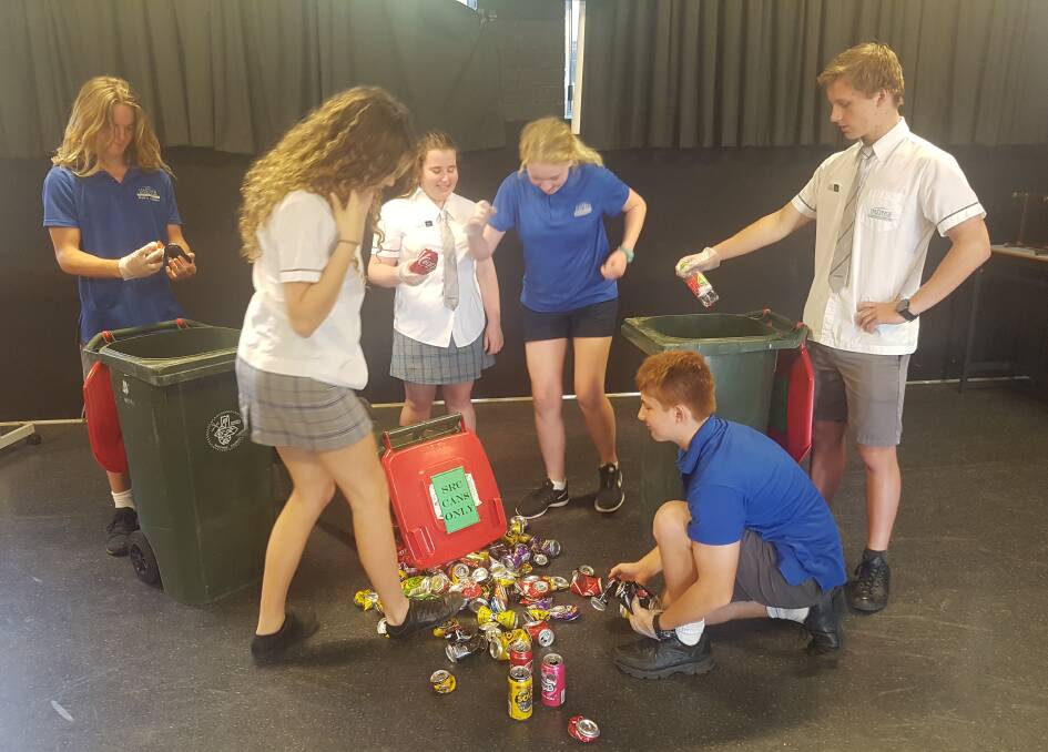 Students sorting the cans and bottles they collected at school.