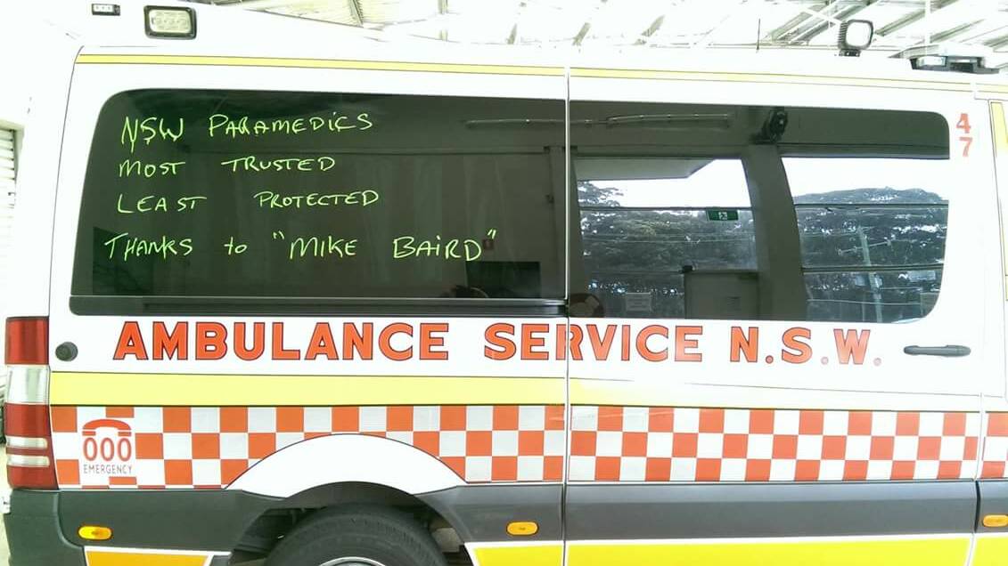 Paramedic cover: The slogans which are written on the side of Port Macquarie ambulances criticise the NSW government changes to death and disability insurance.