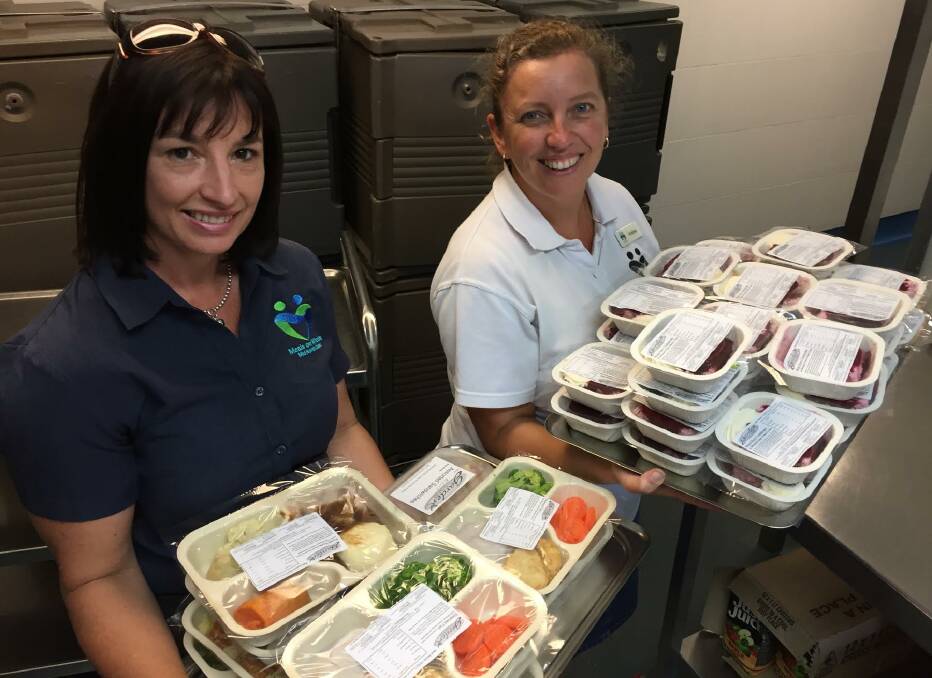 Nutrition: Meals on Wheels Mid North Coast operations manager Penny Poulton with branch service officer Kristine Fallon display an assortment of meals and desserts available through the service. 