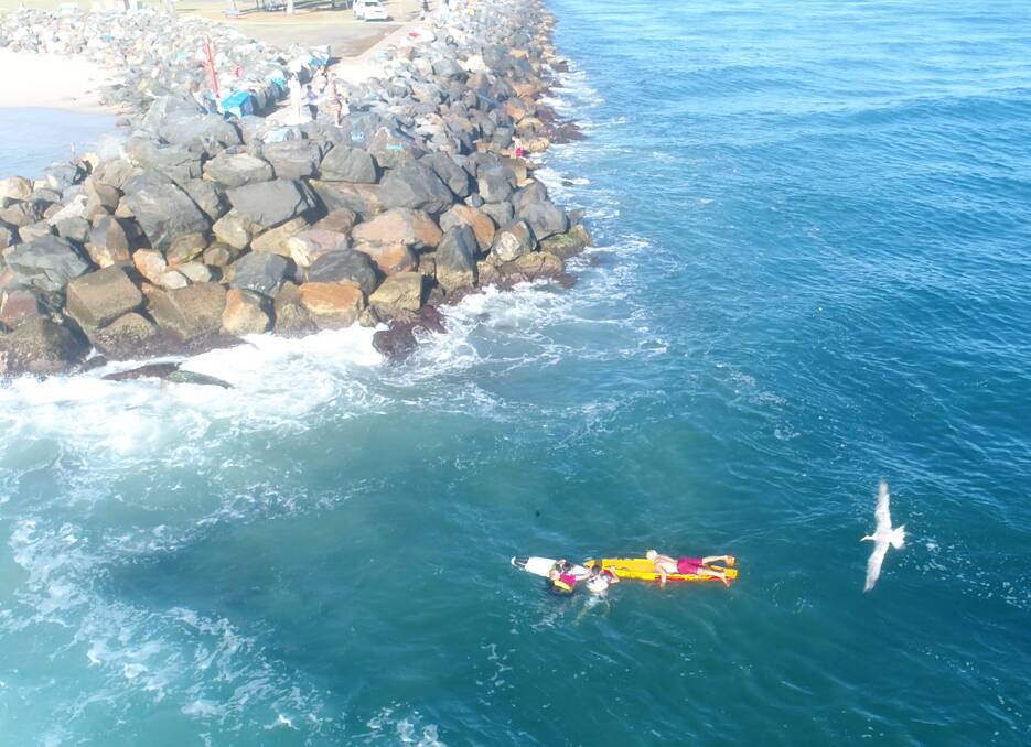 Rip rescue: Lifeguards rescue the duo from a dangerous rip at the Hastings entrance. Photo: ALS NSW