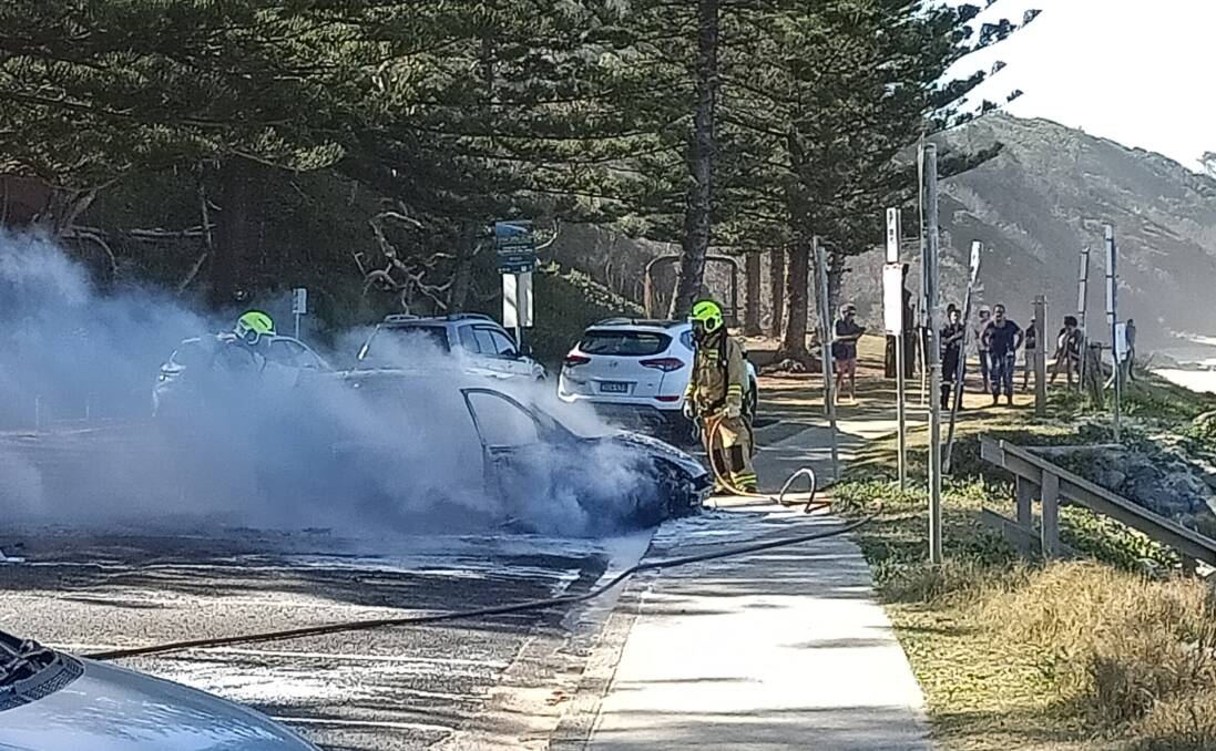 The car was destroyed by fire while in the carpark at Shelly Beach, Port Macquarie. Photo and video courtesy: Steve Drew.